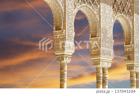 Arches in Islamic (Moorish) style (against the sunset) in Alhambra, Granada, Spain 137043284