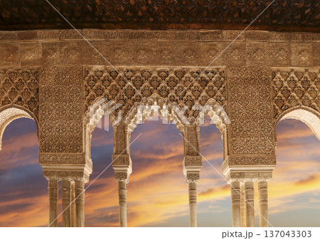 Arches in Islamic (Moorish) style (against the sunset) in Alhambra, Granada, Spain 137043303