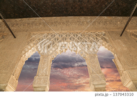 Arches in Islamic (Moorish) style (against the sunset) in Alhambra, Granada, Spain 137043310
