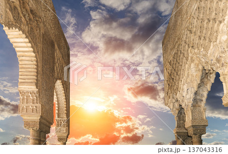 Arches in Islamic (Moorish) style (against the sunset) in Alhambra, Granada, Spain 137043316