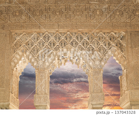 Arches in Islamic (Moorish) style (against the sunset) in Alhambra, Granada, Spain 137043328