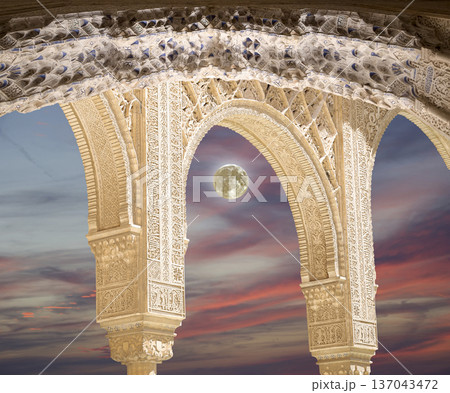 Arches in Islamic (Moorish)  style (against the sunset and supermoon) in Alhambra, Granada, Spain 137043472