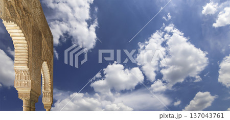 Arches in Islamic (Moorish) style (against the background of a beautiful sky with clouds) in Alhambra, Granada, Spain 137043761
