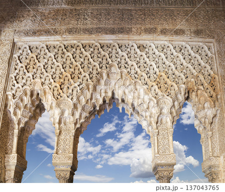 Arches in Islamic (Moorish) style (against the background of a beautiful sky with clouds) in Alhambra, Granada, Spain 137043765