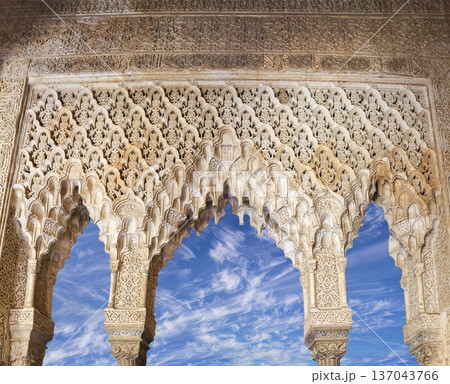 Arches in Islamic (Moorish) style (against the background of a beautiful sky with clouds) in Alhambra, Granada, Spain 137043766