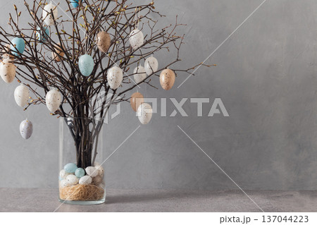 Easter tree with pastel eggs in vase on grey background Easter tree with pastel eggs in vase on grey background 137044223