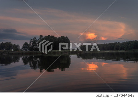 Colourful landscape of nature with lake sky and trees. Beatiful lakeside with reflections of sky in the water Colourful landscape of nature with lake sky and trees. Beatiful lakeside with reflections of sky in the water 137044648