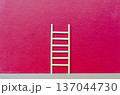 Small wooden ladder on bright red background with customizable space for text or ideas, expressing creative progress and positive change concept. 137044730