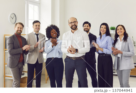 Group of happy diverse business people looking at the camera, smiling and applauding. Group of happy diverse business people looking at the camera, smiling and applauding. 137044941