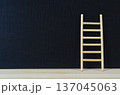 Wooden ladder leaning on deep dark cover with customizable space for text or ideas. 137045063