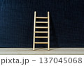 Wooden ladder on dark cover background with customizable space for text or ideas, symbolizing progress, growth mindset, and career advancement concept 137045068