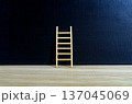 Wooden ladder on dark gradient background with customizable space for text or ideas, conveying leadership and strategic growth concept. 137045069