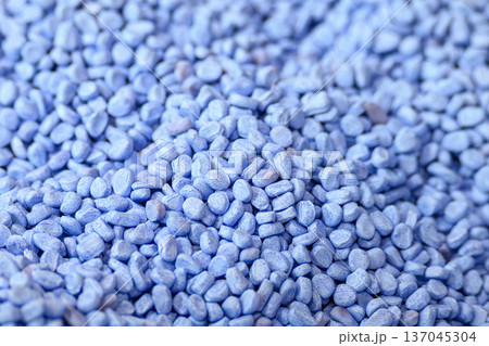 Macro view of high quality blue thermoplastic polymer granules (pellets) for industrial plastic injection molding and extrusion processes. 137045304