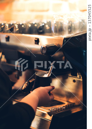 Close up Barista Steaming Milk on Espresso Machine in Cafe Close up Barista Steaming Milk on Espresso Machine in Cafe 137045525
