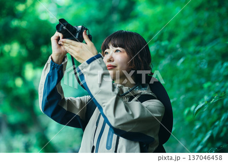 緑地をハイキングして写真を撮る若い女性 137046458