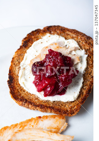 Open sandwich from leftover turkey and cranberry sauce Open sandwich from leftover turkey and cranberry sauce 137047345