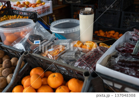 Market stall with churchkhela sweets, mandarins, kiwifruit, and citrus fruits arranged in crates with natural colors and rustic textures. Food marketing, culinary tourism, local product promotion Market stall with churchkhela sweets, mandarins, kiwifruit, and citrus fruits arranged in crates with natural colors and rustic textures. Food marketing, culinary tourism, local product promotion 137048308