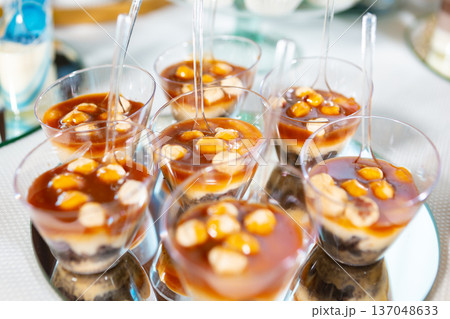 Delicious Layered Dessert Cups With Caramel and Almonds Served at a Festive Event Delicious Layered Dessert Cups With Caramel and Almonds Served at a Festive Event 137048633