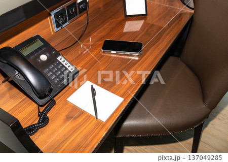 Guest workspace with room service phone on desk. Guest workspace with room service phone on desk. 137049285