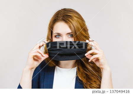 Female using protective face mask. Female using protective face mask. 137049416
