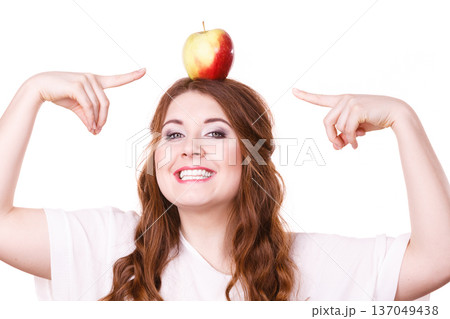 Woman funny girl holds on head apple fruit Woman funny girl holds on head apple fruit 137049438