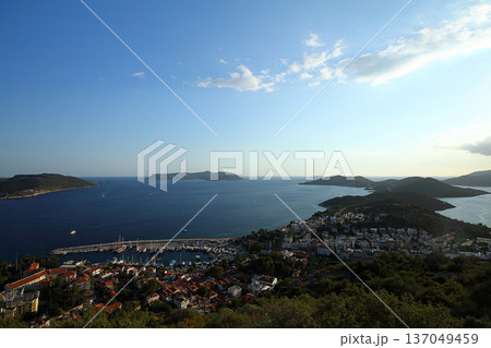 View from the bird's eye of the Kas city district of Antalya Province of Turkey Asia. Colorful spring sunset in small Mediterranean yachting and tourist town. 137049459