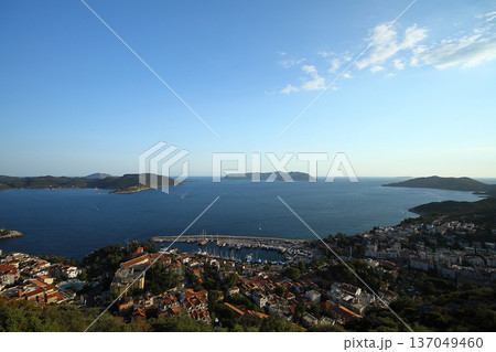 View from the bird's eye of the Kas city district of Antalya Province of Turkey Asia. Colorful spring sunset in small Mediterranean yachting and tourist town. View from the bird's eye of the Kas city district of Antalya Province of Turkey Asia. Colorful spring sunset in small Mediterranean yachting and tourist town. 137049460