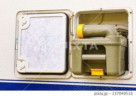 Serving caravan in dump station., tank toilet cassette 137049518