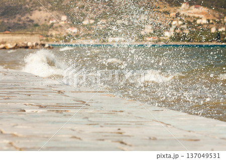 Water splashing on jetty pier Water splashing on jetty pier 137049531