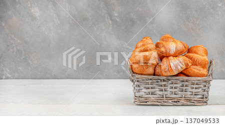 Golden croissants in wicker basket on light table with copy space Golden croissants in wicker basket on light table with copy space 137049533