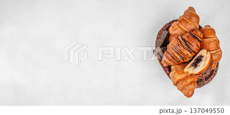 Top view basket of chocolate croissants on light background Top view basket of chocolate croissants on light background 137049550