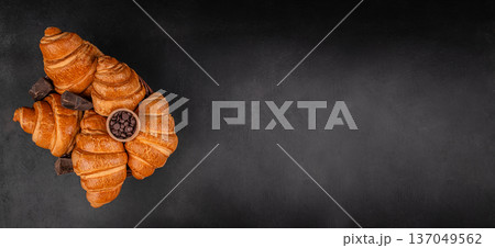 Croissants with chocolate pieces on dark background top view Croissants with chocolate pieces on dark background top view 137049562