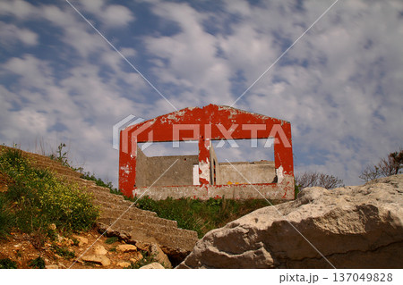 ruined red house with blue sky. 137049828
