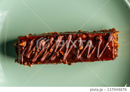 Chocolate glazed cake bar with nuts Chocolate glazed cake bar with nuts 137049876