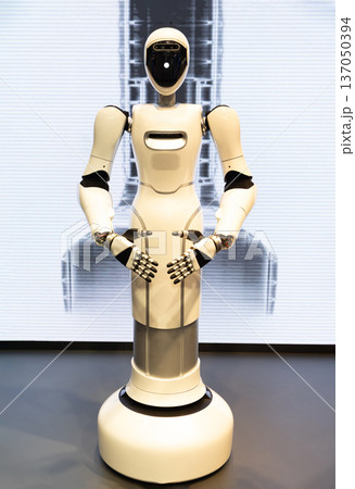 Advanced humanoid robot standing in modern exhibition Advanced humanoid robot standing in modern exhibition 137050394
