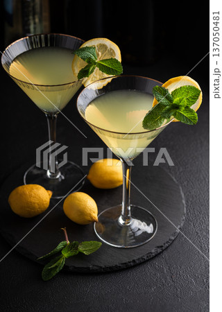 Elegant cocktail two glasses of limoncello spritz, garnished with fresh lemon slices and mint sprigs Elegant cocktail two glasses of limoncello spritz, garnished with fresh lemon slices and mint sprigs 137050481