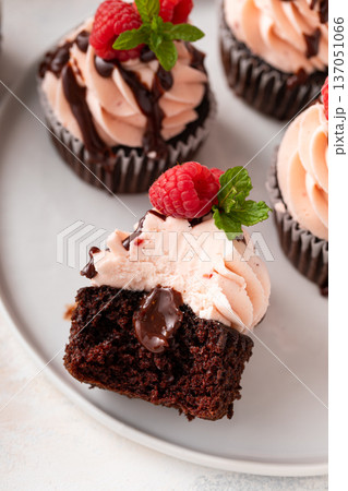 Raspberry chocolate cupcakes with fresh raspberries and chocolate sauce Raspberry chocolate cupcakes with fresh raspberries and chocolate sauce 137051066