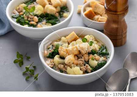 Healthy bean and turkey soup or stew with kale and cauliflower Healthy bean and turkey soup or stew with kale and cauliflower 137051083