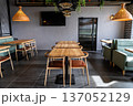 Contemporary restaurant interior with wooden tables and modern cozy dining area 137052129