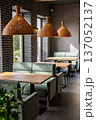 Stylish modern restaurant interior with cozy seating and natural light from large windows 137052137