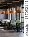 Stylish modern restaurant interior with cozy seating and natural light from large windows 137052141