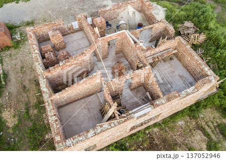Aerial view of building site for future house, brick basement floor and stacks of brick for construction. Aerial view of building site for future house, brick basement floor and stacks of brick for construction. 137052946