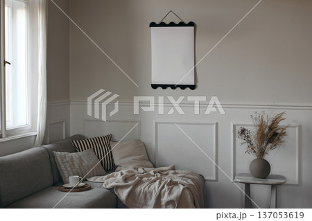 Blank Poster Frame Mockup in Living Room Interior. Scandinavian Home Decor with Sofa at window. Neutral Beige Wall Background. Cup of coffee. Modern Empty Template for Artwork, Branding, Print display Blank Poster Frame Mockup in Living Room Interior. Scandinavian Home Decor with Sofa at window. Neutral Beige Wall Background. Cup of coffee. Modern Empty Template for Artwork, Branding, Print display 137053619
