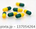 Green and yellow Tramadol capsule pills isolated on white background. 137054264