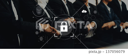 Professional business team collaborating on cybersecurity solutions with digital lockpad graphic to illustrate data protection and safe communication in the workplace Trope Professional business team collaborating on cybersecurity solutions with digital lockpad graphic to illustrate data protection and safe communication in the workplace Trope 137056079