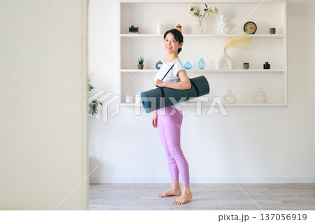 ヨガマットを持つ女性 137056919