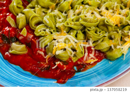 Italian spinach tortellini pasta with tomato sauce 137058219