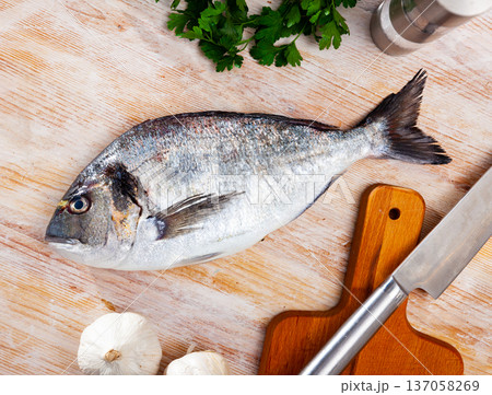 Fresh gilthead bream with greens and spices Fresh gilthead bream with greens and spices 137058269