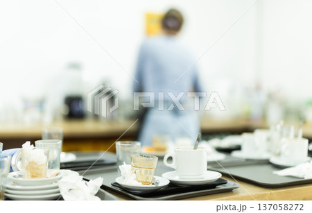 Messy counter in cafeteria cluttered with used dish Messy counter in cafeteria cluttered with used dish 137058272