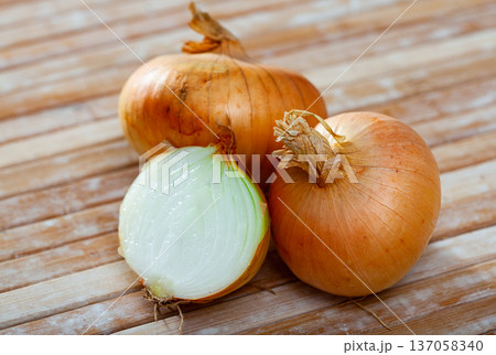 Ripe onions on wooden table Ripe onions on wooden table 137058340